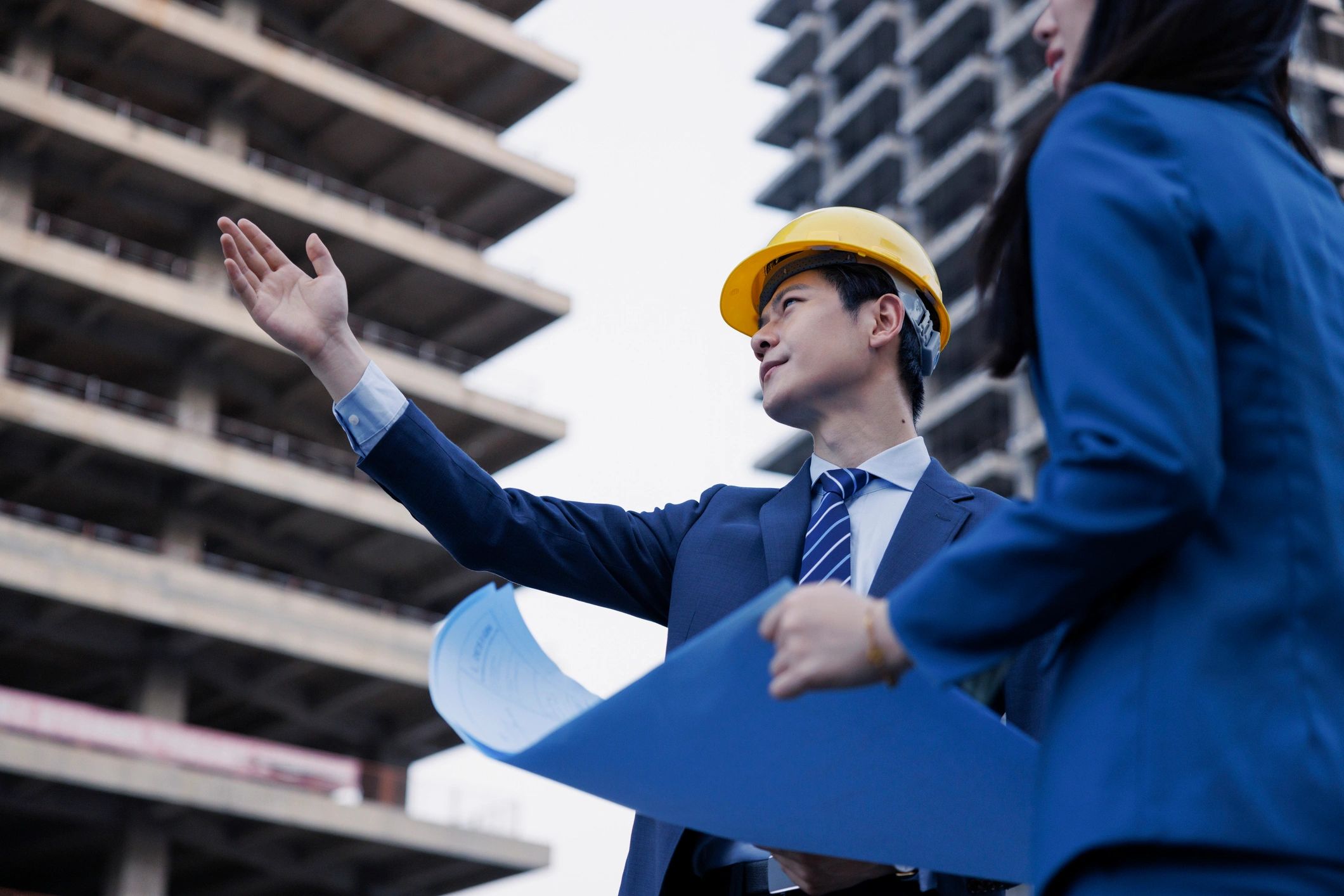 Construction engineers reviewing plans on a job site